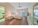 Main bedroom with wood-look floors, high ceiling, and ensuite bathroom at 8382 Creekview Ln, Englewood, FL 34224