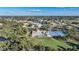 Aerial view of community pool, tennis courts, and clubhouse at 8382 Creekview Ln, Englewood, FL 34224