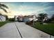 Charming house exterior with a red tile roof and landscaping at 8382 Creekview Ln, Englewood, FL 34224