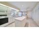 Kitchen features white cabinets, an island, and a breakfast nook at 8382 Creekview Ln, Englewood, FL 34224