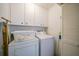 Laundry room with washer, dryer and cabinets at 8382 Creekview Ln, Englewood, FL 34224