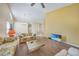 Living room features wood-look floors and a vaulted ceiling at 8382 Creekview Ln, Englewood, FL 34224