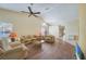 Spacious living room with wood-look floors and lots of natural light at 8382 Creekview Ln, Englewood, FL 34224