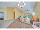 Bright living room with wood-look floors, access to a screened porch at 8382 Creekview Ln, Englewood, FL 34224