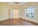 Open living room with wood flooring and access to other rooms at 8382 Creekview Ln, Englewood, FL 34224