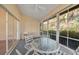 Enjoy relaxing views from this screened lanai, featuring a table and chairs at 8382 Creekview Ln, Englewood, FL 34224