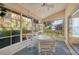 Sunroom with table and chairs, offering a view of the outdoors at 8382 Creekview Ln, Englewood, FL 34224
