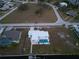 High-angle view of the house, pool, and surrounding area at 174 Severin Se Rd, Port Charlotte, FL 33952
