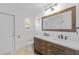 Bathroom with double vanity and large mirror at 174 Severin Se Rd, Port Charlotte, FL 33952