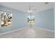 Bright bedroom with light blue walls and two windows at 174 Severin Se Rd, Port Charlotte, FL 33952