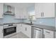 Modern kitchen with stainless steel appliances and light blue backsplash at 174 Severin Se Rd, Port Charlotte, FL 33952