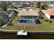 Aerial view showcasing the pool, dock, and canal views at 1120 La Palma Ct, Punta Gorda, FL 33950