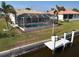 Private backyard oasis featuring a screened pool and dock access at 1120 La Palma Ct, Punta Gorda, FL 33950