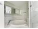 Round soaking tub with glass enclosure and marble tile at 1425 Park Beach Cir # 149, Punta Gorda, FL 33950