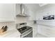 Modern kitchen boasts stainless steel appliances and white cabinetry at 1425 Park Beach Cir # 149, Punta Gorda, FL 33950