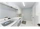 Bright laundry room with washer, dryer, and cabinets at 1425 Park Beach Cir # 149, Punta Gorda, FL 33950