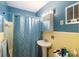 Bathroom with pedestal sink and blue walls at 22158 Marshall Ave, Port Charlotte, FL 33952