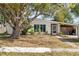 House with mature tree and driveway at 22158 Marshall Ave, Port Charlotte, FL 33952