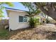 Side view of house with large tree and canoe at 22158 Marshall Ave, Port Charlotte, FL 33952