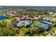 Aerial view of community pool, tennis courts, and clubhouse at 2427 Daisy Dr, North Port, FL 34289