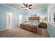 Bright bedroom with wooden bed frame and ensuite bathroom access at 2427 Daisy Dr, North Port, FL 34289