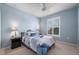 Light blue bedroom with double bed, nightstands, and window shutters at 2427 Daisy Dr, North Port, FL 34289