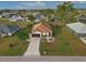 Aerial view of single-story house with driveway and landscaped yard at 25554 Prada Dr, Punta Gorda, FL 33955