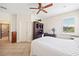 Bright bedroom with a queen bed, built-in desk, and en-suite bathroom at 25554 Prada Dr, Punta Gorda, FL 33955