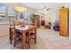 Bright dining area with a wooden table and chairs, adjacent to the living room at 25554 Prada Dr, Punta Gorda, FL 33955