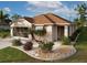 Single-story home with a brown tile roof, landscaped yard, and screened garage at 25554 Prada Dr, Punta Gorda, FL 33955