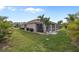 Single-story house with screened porch and palm trees at 25554 Prada Dr, Punta Gorda, FL 33955