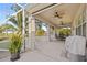 Spacious screened porch with patio furniture and ceiling fan at 25554 Prada Dr, Punta Gorda, FL 33955