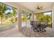 Relaxing screened porch with table and chairs, overlooking backyard at 25554 Prada Dr, Punta Gorda, FL 33955