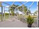 Screened patio with lounge chair and lush landscaping view at 25554 Prada Dr, Punta Gorda, FL 33955