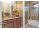 Elegant bathroom with a granite vanity, tiled shower, and soaking tub at 2863 Mill Creek Rd, Port Charlotte, FL 33953