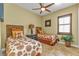 Cozy bedroom with two twin beds, window seating, and ceiling fan at 2863 Mill Creek Rd, Port Charlotte, FL 33953