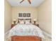 Comfortable bedroom with a queen bed, ceiling fan, and tile floors at 2863 Mill Creek Rd, Port Charlotte, FL 33953