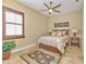 Spacious bedroom with a queen bed, ceiling fan, and tile floors at 2863 Mill Creek Rd, Port Charlotte, FL 33953