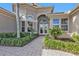 Elegant front entry with double doors and landscaping at 2863 Mill Creek Rd, Port Charlotte, FL 33953