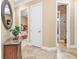 Bright hallway with tile flooring and access to bedrooms and bathrooms at 2863 Mill Creek Rd, Port Charlotte, FL 33953