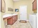 Bright laundry room with washer, dryer, and built-in cabinets at 2863 Mill Creek Rd, Port Charlotte, FL 33953