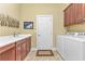 Bright laundry room with washer, dryer, and built-in cabinets at 2863 Mill Creek Rd, Port Charlotte, FL 33953