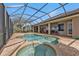 Inviting pool and spa with covered patio; perfect for outdoor entertaining at 2863 Mill Creek Rd, Port Charlotte, FL 33953