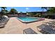 Community pool with plenty of lounge chairs at 311 Garvin St # 309D, Punta Gorda, FL 33950