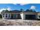 New home features a concrete block exterior, completed roof, and an attached two-car garage at 349 Gold Tree, Punta Gorda, FL 33955