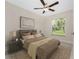 Bright bedroom with large window and ceiling fan at 3672 Vehlin St, North Port, FL 34286