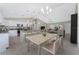 Modern kitchen with white cabinetry, granite countertops, and stainless steel appliances at 3672 Vehlin St, North Port, FL 34286