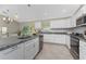 Modern kitchen with white cabinets, granite countertops, and stainless steel appliances at 3672 Vehlin St, North Port, FL 34286