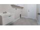 Laundry room with utility sink and cabinets at 3672 Vehlin St, North Port, FL 34286