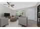 Bright and airy living room with gray sofas and a large flat-screen TV at 3672 Vehlin St, North Port, FL 34286